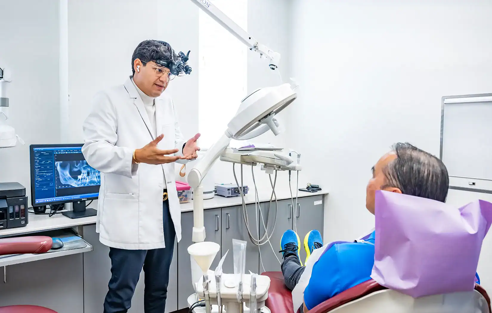 Periodontist consulting with a patient at Perio Implant Health Professionals